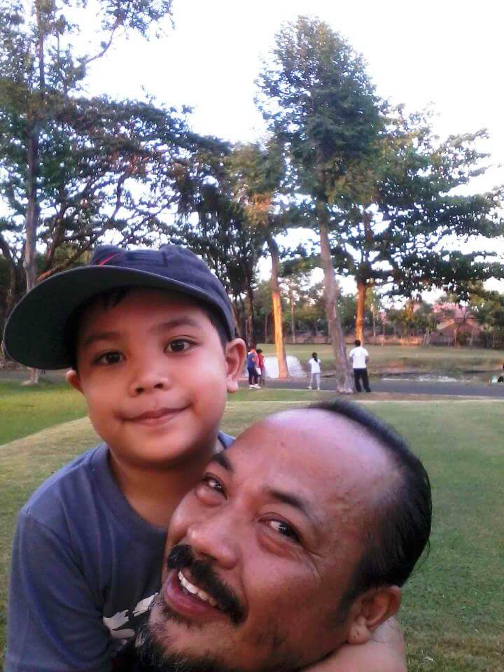 There he is having fun with his Lolo at the pond.