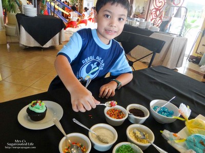 Little MrC designing his own cupcake.