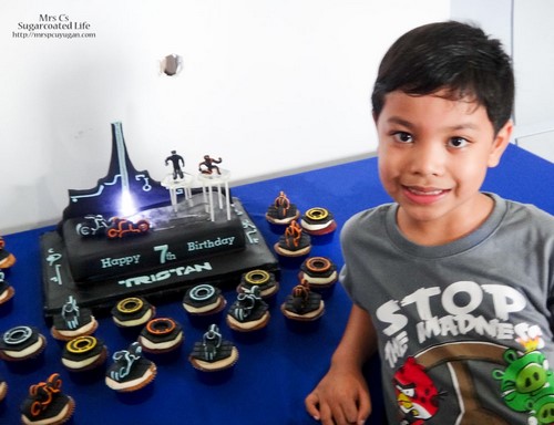 The birthday boy with his birthday cake.