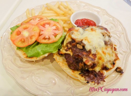 Emmental & Mozzarella Cheeseburger With mushroom, caramelized onion, tomato and lettuce with a side of fries.